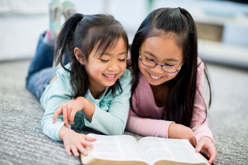 2 girls reading bible