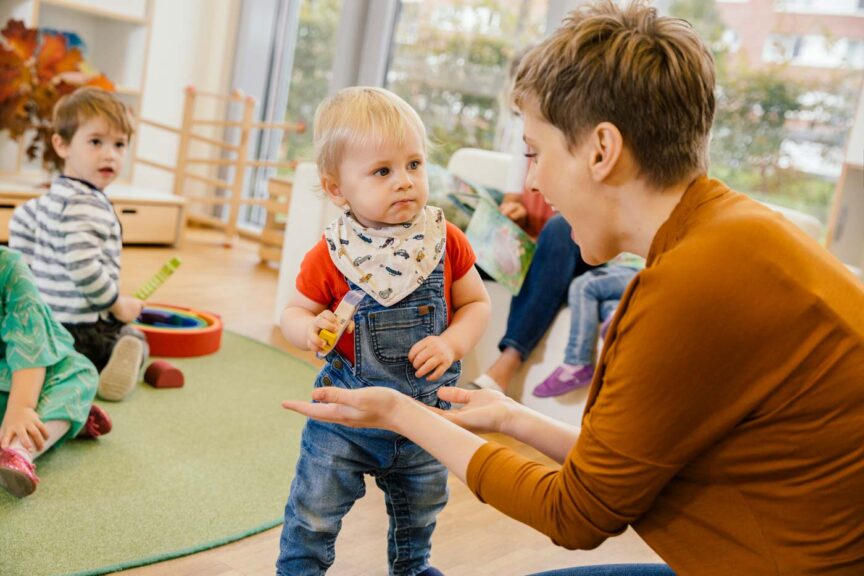 baby in a classroom with a woman