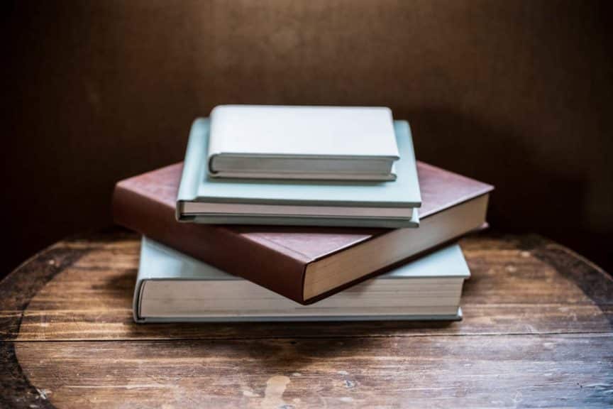 High angle close up of stack of books on wooden table