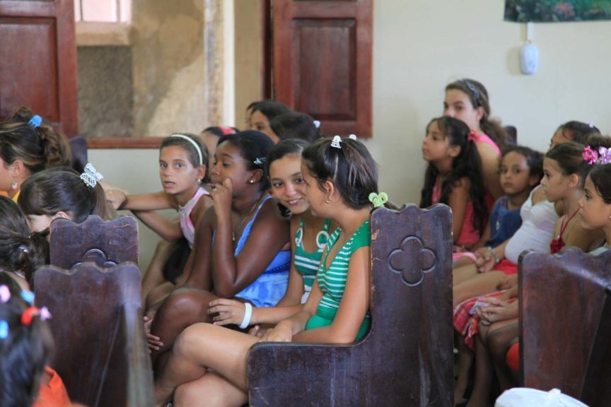 children sitting in church talking