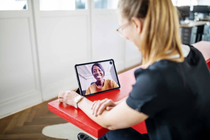 Female executives having video call in office