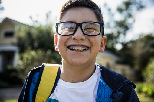 School age boy laughing outside