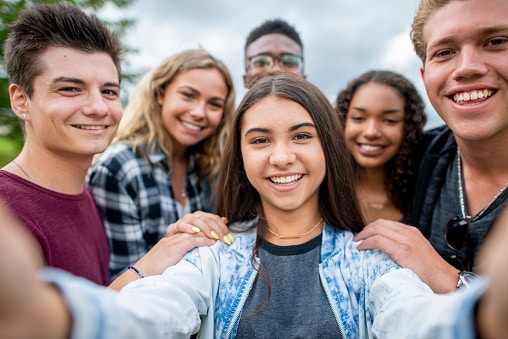 a group of teens taking a selfie