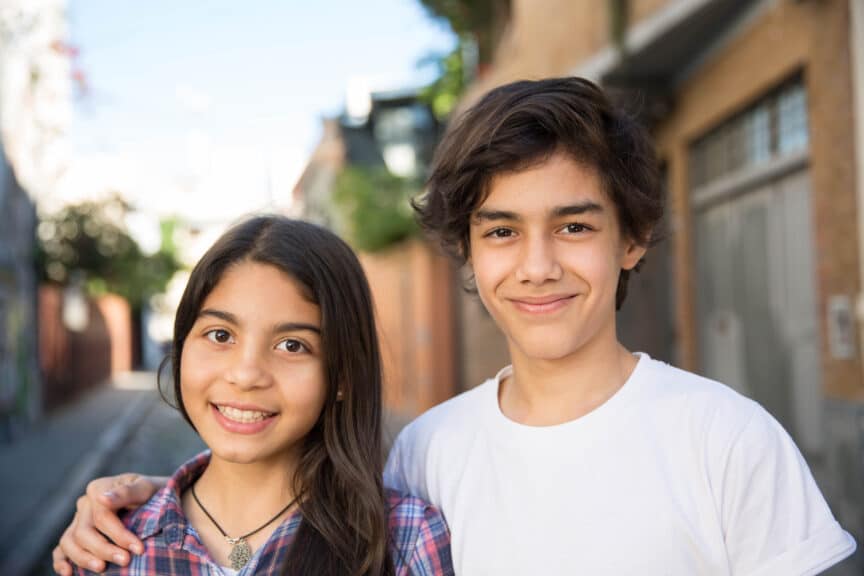 girl and boy with arm around each other