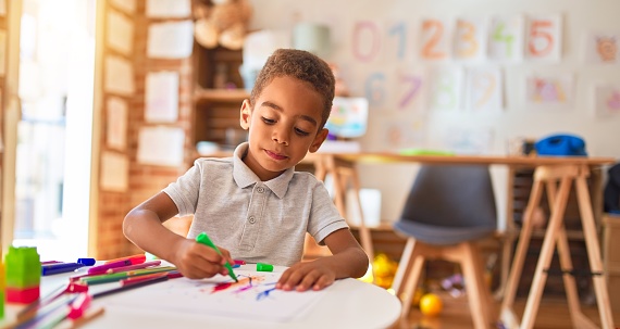 toddler coloring in classroom