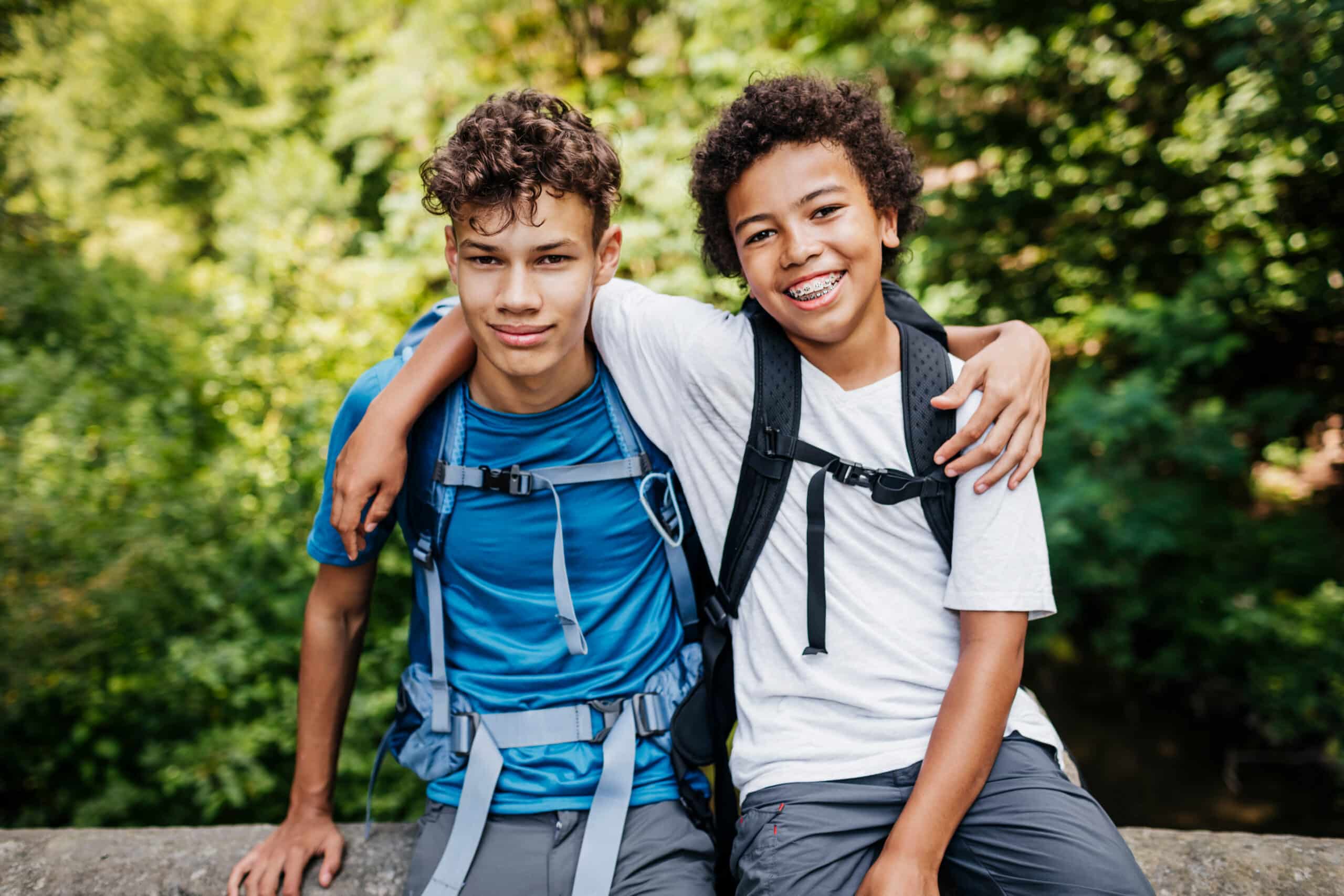 two preteen boys with arms around each other