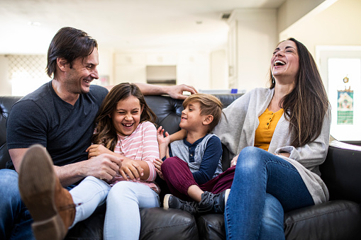 family laughing on couch