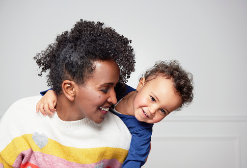 mom piggy backing young toddler