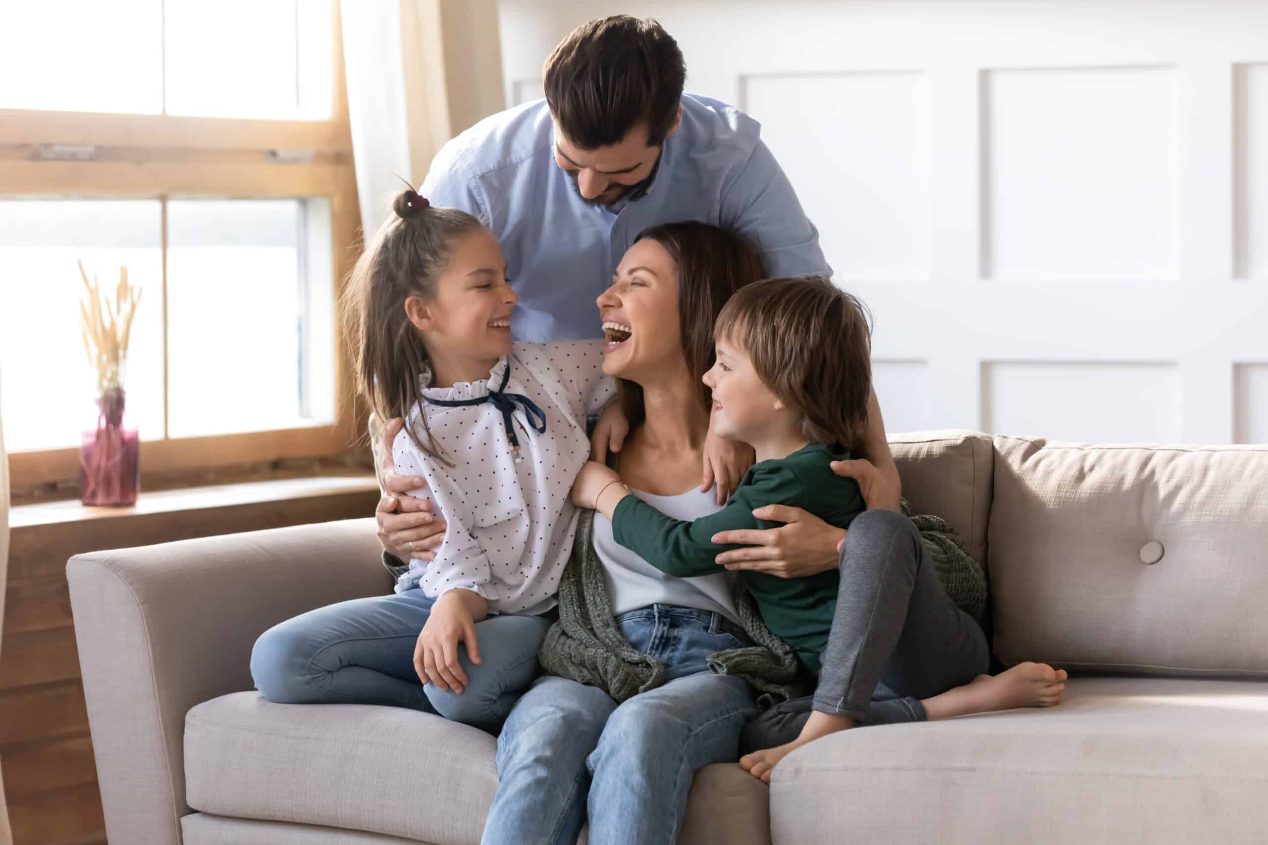 family laughing on couch