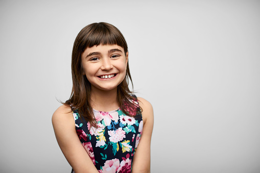 Smiling Girl Against Gray Background