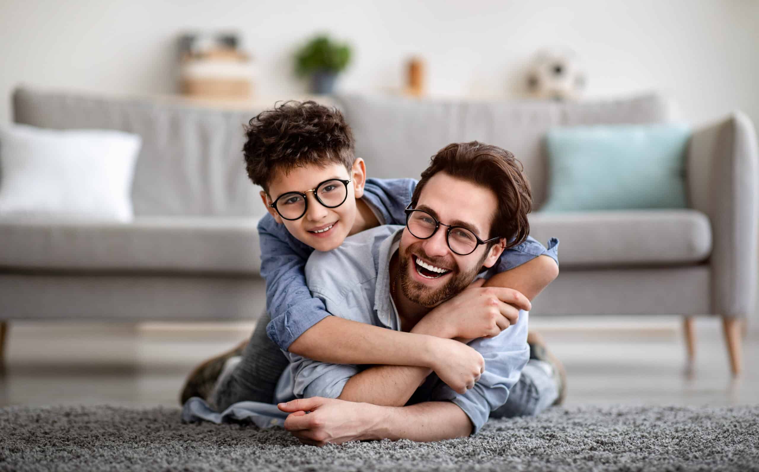 father and son lying on floor