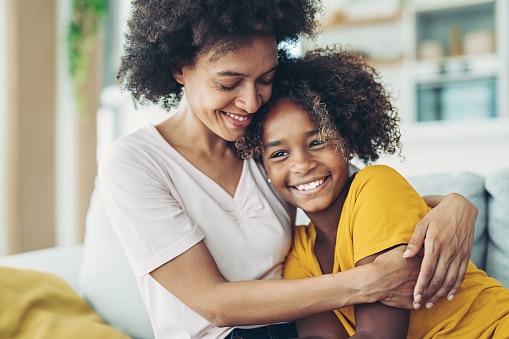 African american mother and daughter hugging