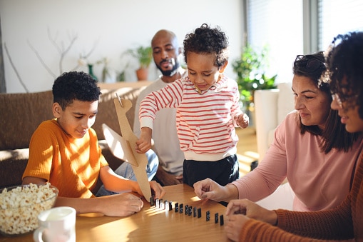 multiracial family playing dominos