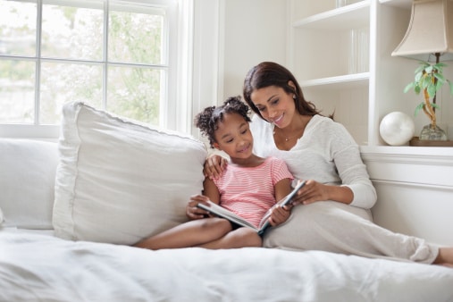 mother and daughter reading a book