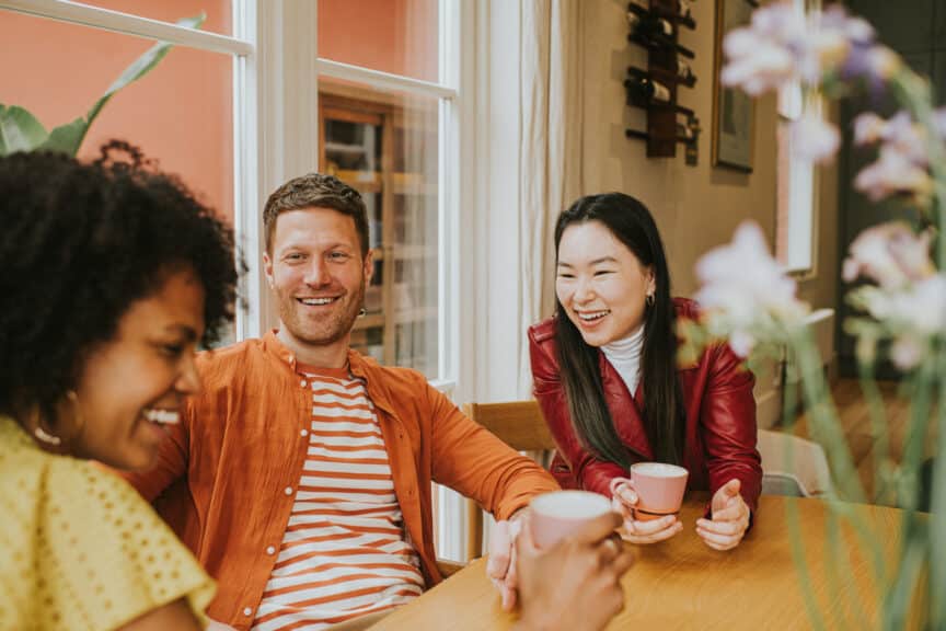 Friends having coffee and smiling