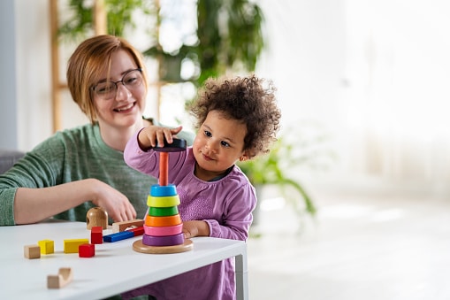 mother watching child play