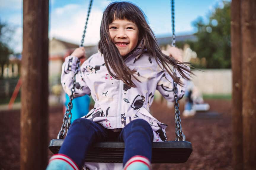 toddler girl on swing