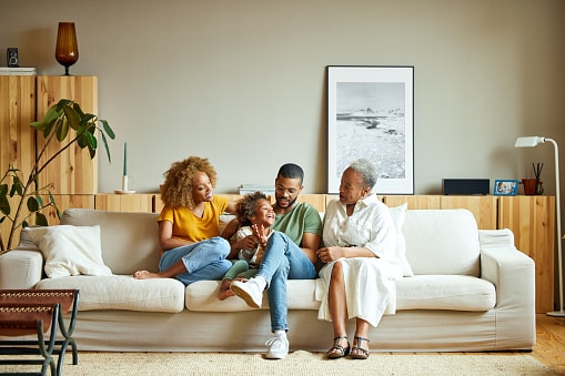 african american family sitting on couch with grandma