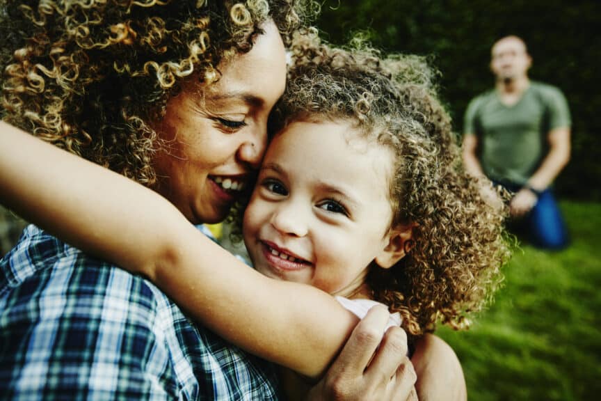 mom holding daughter