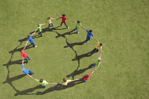 children in a circle holding hands
