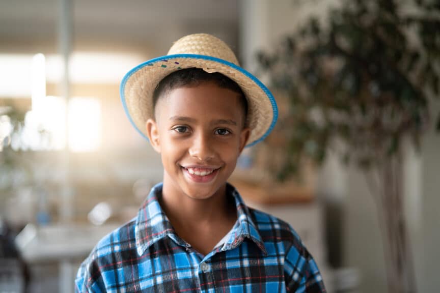 smiling boy with hat