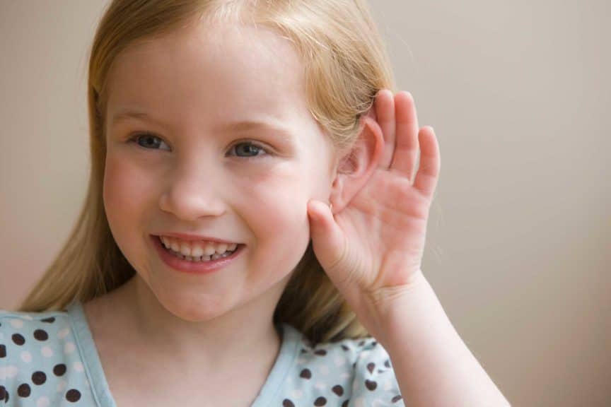 Girl cupping ear to hear better