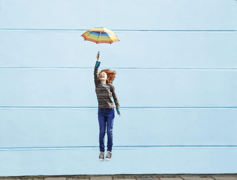 Girl jumping with umbrella