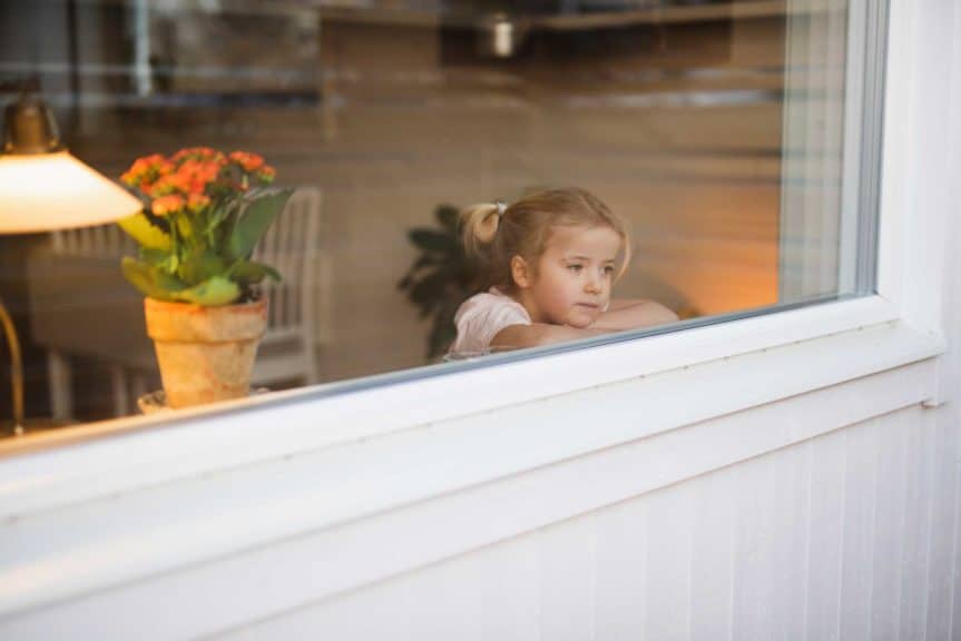 Girl looking through window