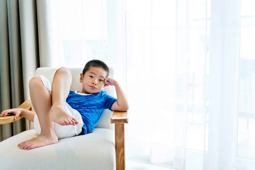 Little boy relaxing in armchair