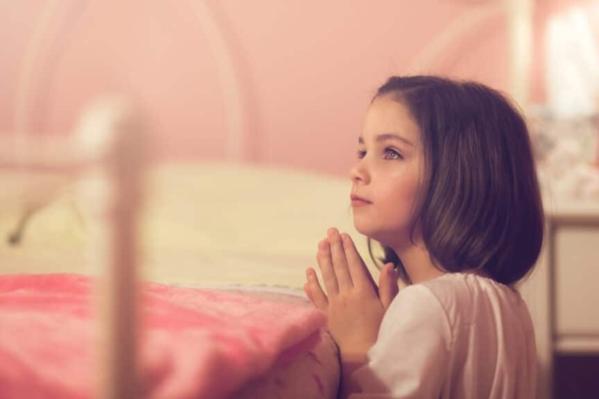 Little girl saying her bedtime prayers