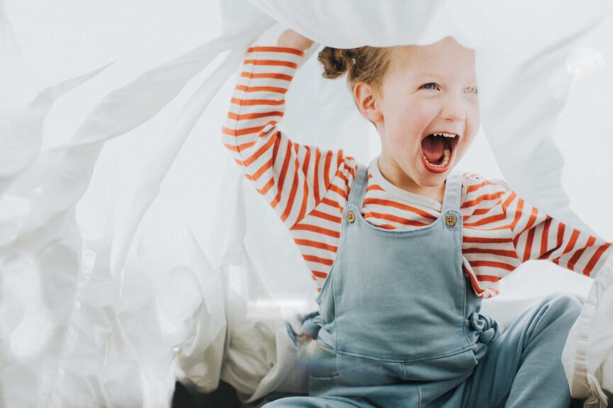 Playful Girl under a White Sheet