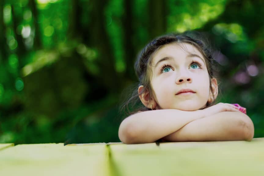 Portrait of a beautiful little girl in the forest