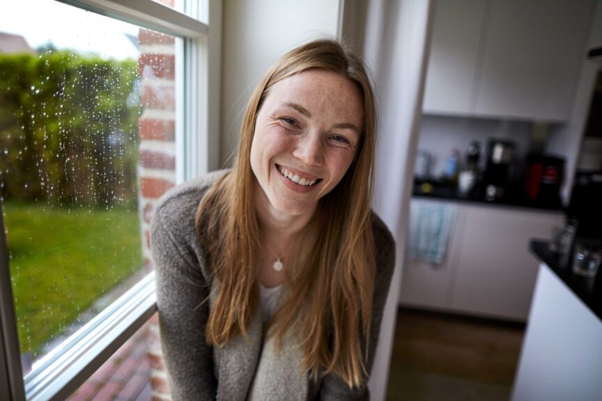 Portrait of happy young woman in kitchen