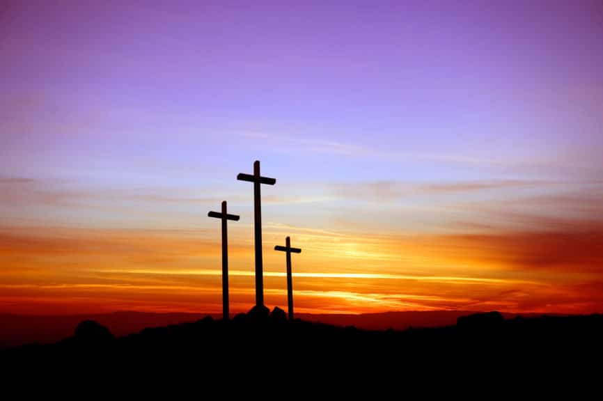 Three crosses standing at the sunset