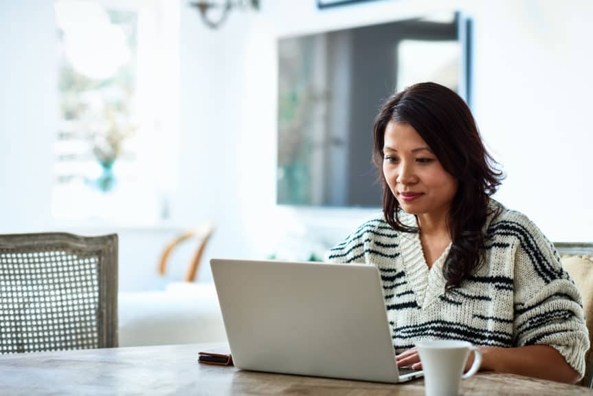 Woman using laptop and working from home