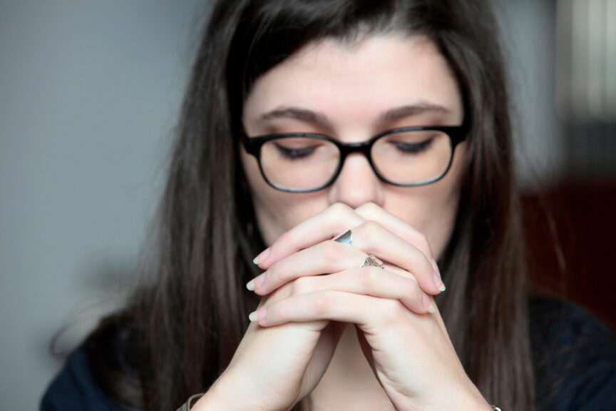 Young woman praying in a church