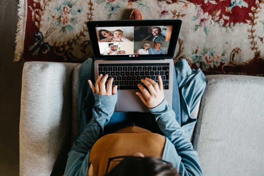 Young woman using a laptop to connect with her friends and parents