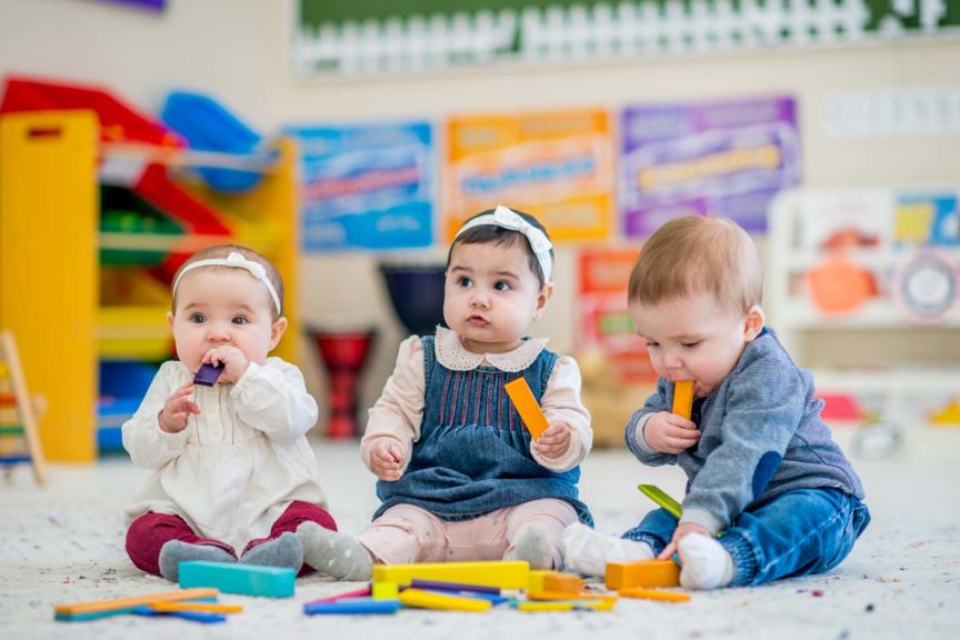 babies playing with blocks