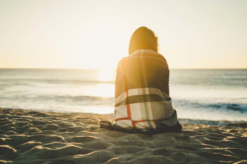 beach-sunset-woman-blanket