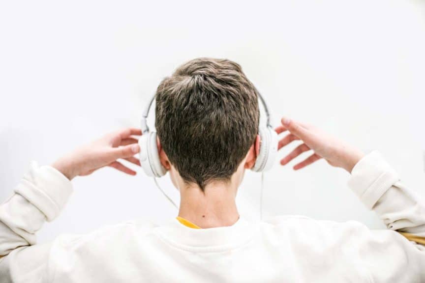 boy listening music with headphones indoor