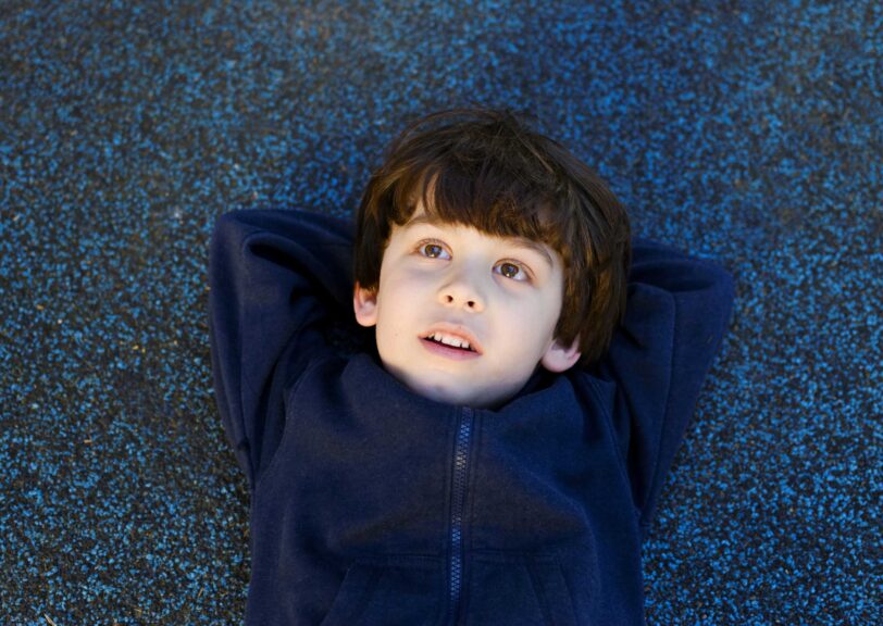 boy lying back gazing up