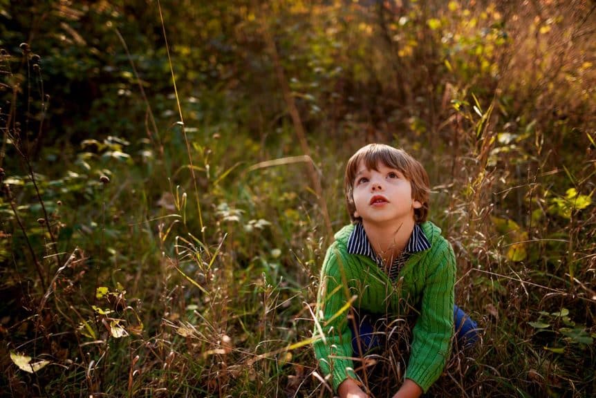 boy sitting in field