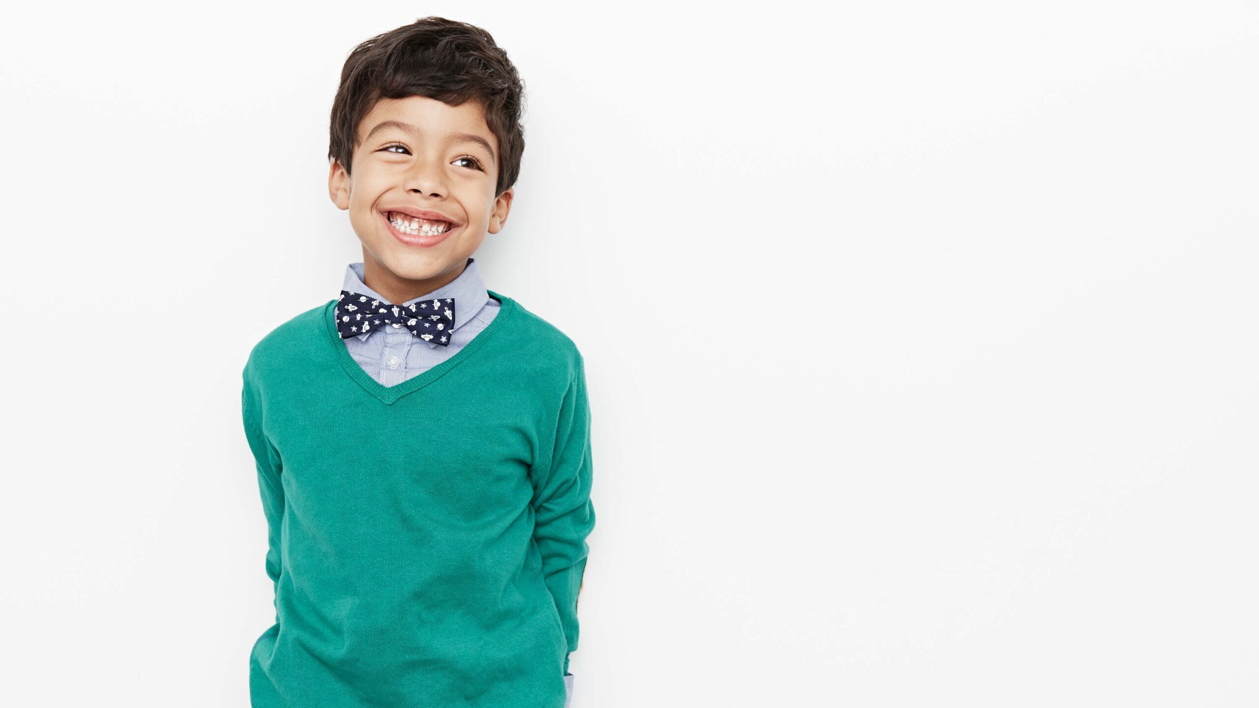 boy with a huge smile and wearing a bow tie.
