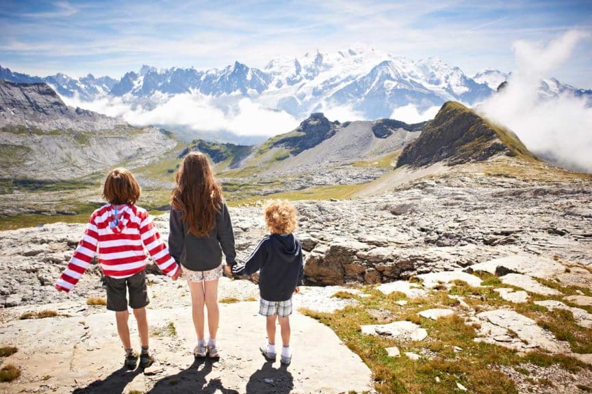 Children standing in rocky landscape