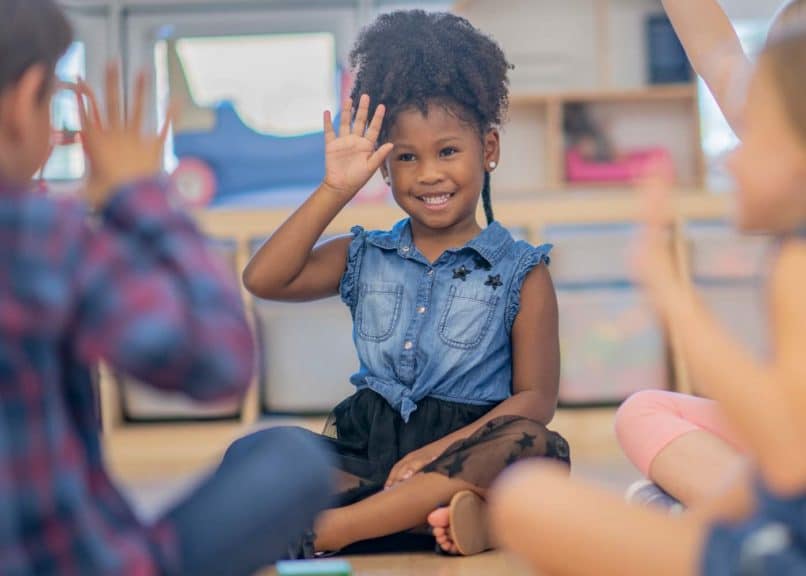 Children waving in kindergarten class