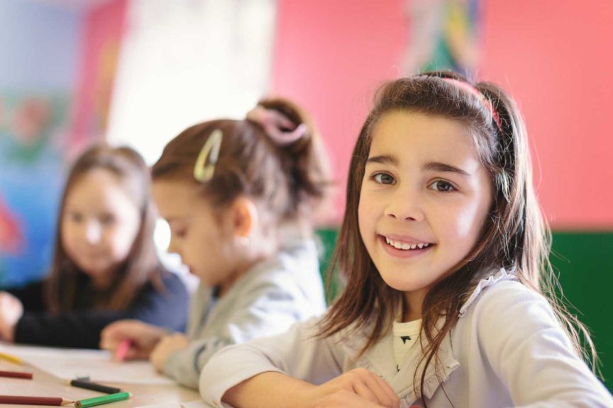 cute-girls-classroom-drawing-smiling