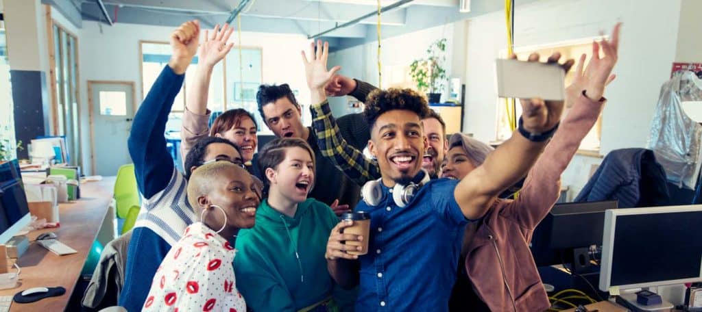 enthusiastic-business-team-selfie-office