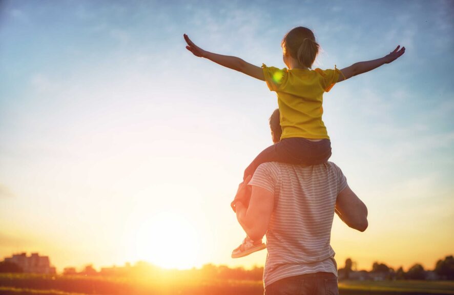 father daughter shoulders beautiful sunset view