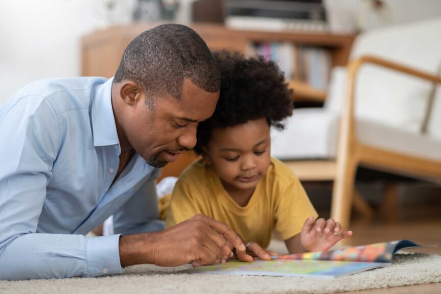 father and daughter reading a book