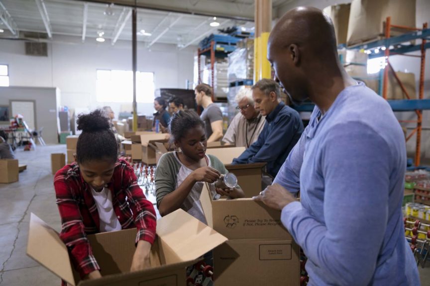 father-daughter-volunteering-filling-boxes